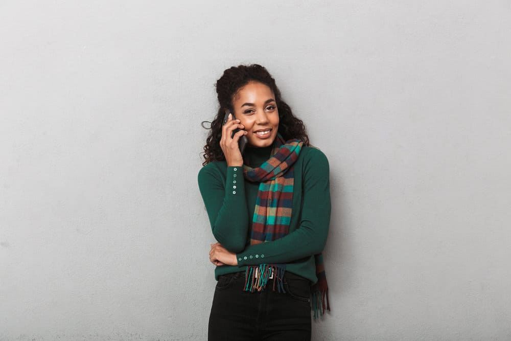 A young African American female with fine hair recently washed her curls with a sulfate-free shampoo.