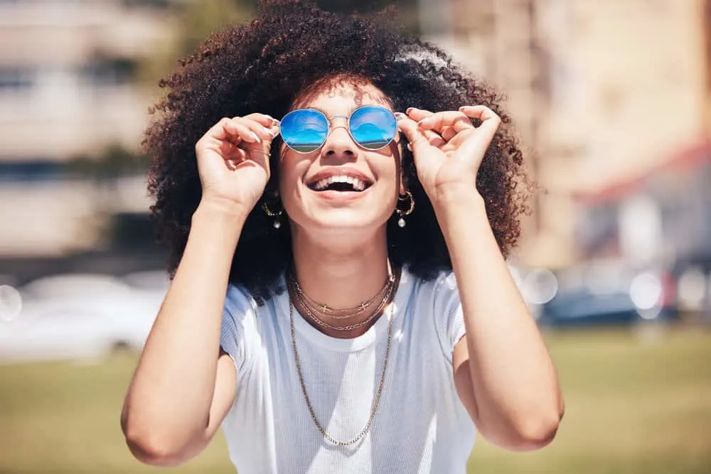 Can You Feel Your Hair Grow On Your Head? Face or Body? 1 A happy black girl with curly hair follicles has been eating a healthy and balanced diet to promote hair growth.