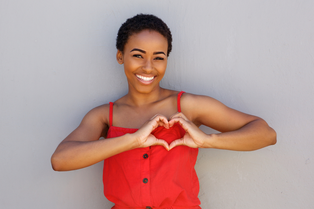 A light-skinned black lady in her early twenties hoping to install a crochet braided hairstyle over tight cornrows.