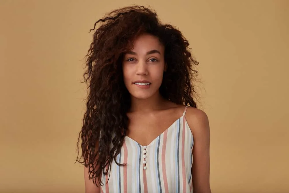 Bumped Ends: How to Bump the Ends of Your Hair at Home 3 A pretty light-skinned lady with split ends from heat damage is wearing her hair straight after removing bobby pins.