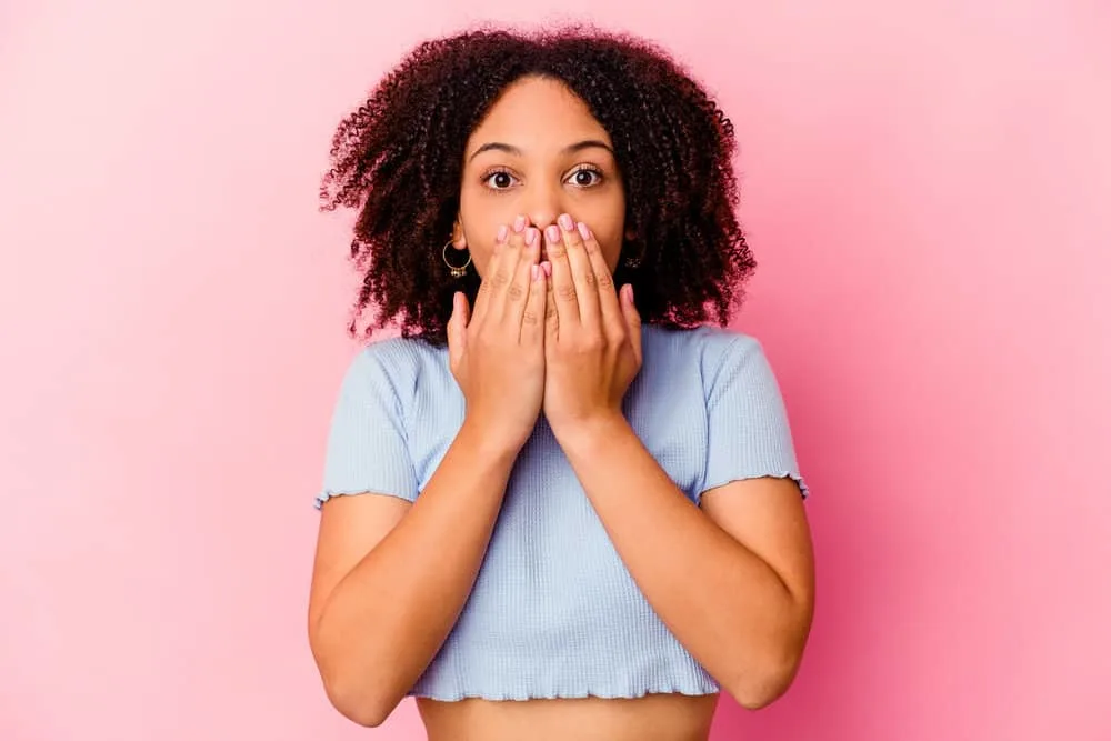 What Is 4A Hair? How To Take Care of It, Styles, and Products 14 African American lady with kinky hair strands with tight coils at the ends.