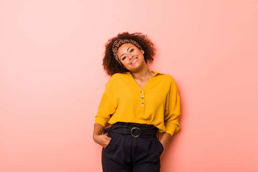 A lady with curly hair cuticles styled with vitamin E oil and castor oil wearing a professional business outfit.