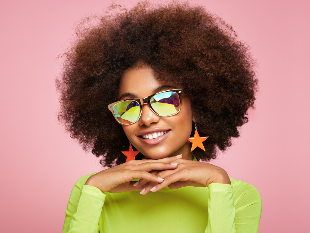 A fashionable young black girl after removing her baby braids to highlight a gorgeous afro with side-swept bangs.