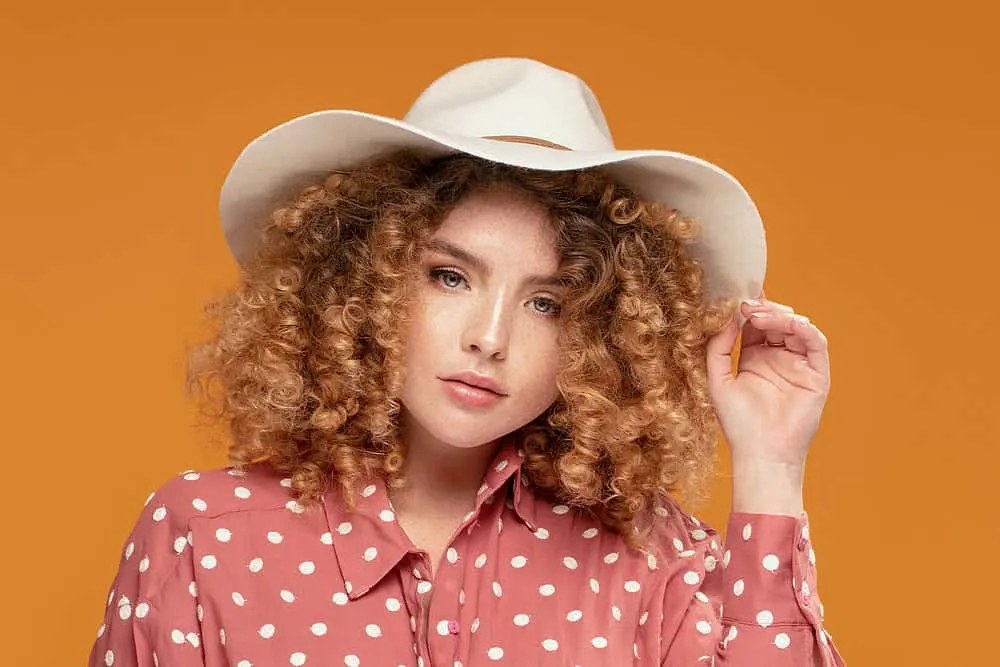 How Long Does Bleached Hair Last and How to Repair Damage 7 White girl with healthy-looking hair strands styled with warm coconut oil and purple shampoo.