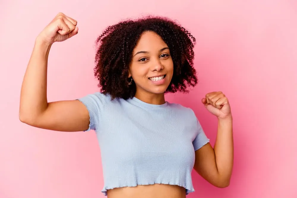 What Is 4A Hair? How To Take Care of It, Styles, and Products 12 African American girl after drying her wet hair and using a leave-in to retain moisture on kinky hair type.