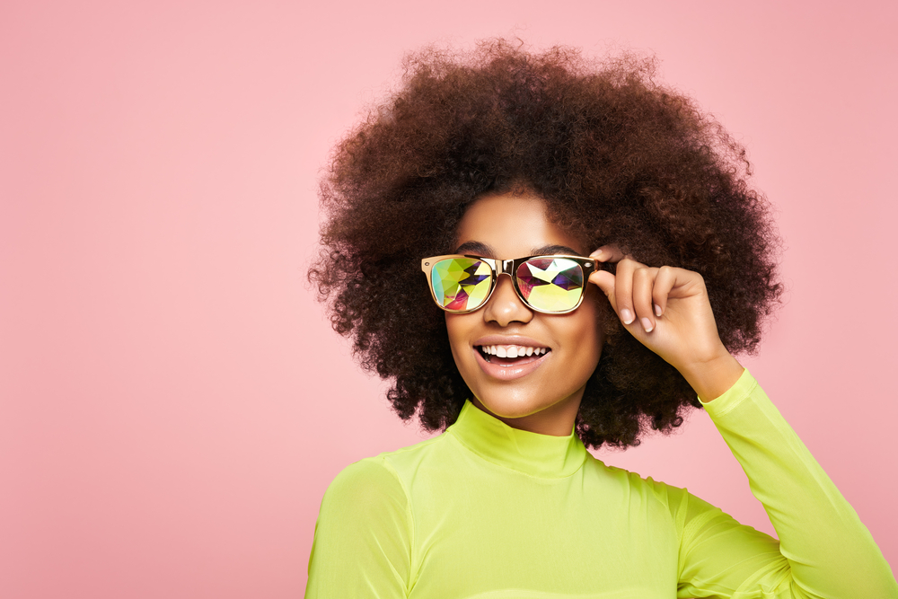 A Bella Hadid-inspired curly hairdo with more volume is worn by this gorgeous black woman.