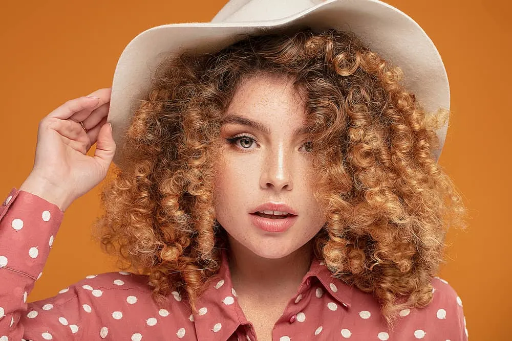 How Long Does Bleached Hair Last and How to Repair Damage 1 Beautiful woman with healthy hair growth on color-treated hair follicles dyed with bleach powder.