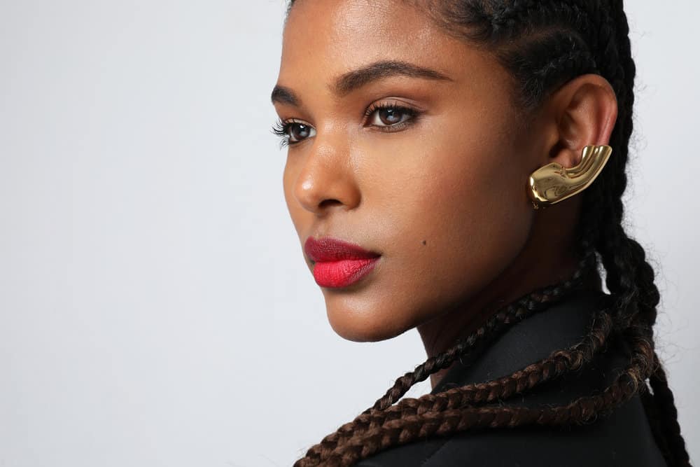 Cute black woman with her natural hair combined with synthetic hair extensions to maintain cornrows for two months.