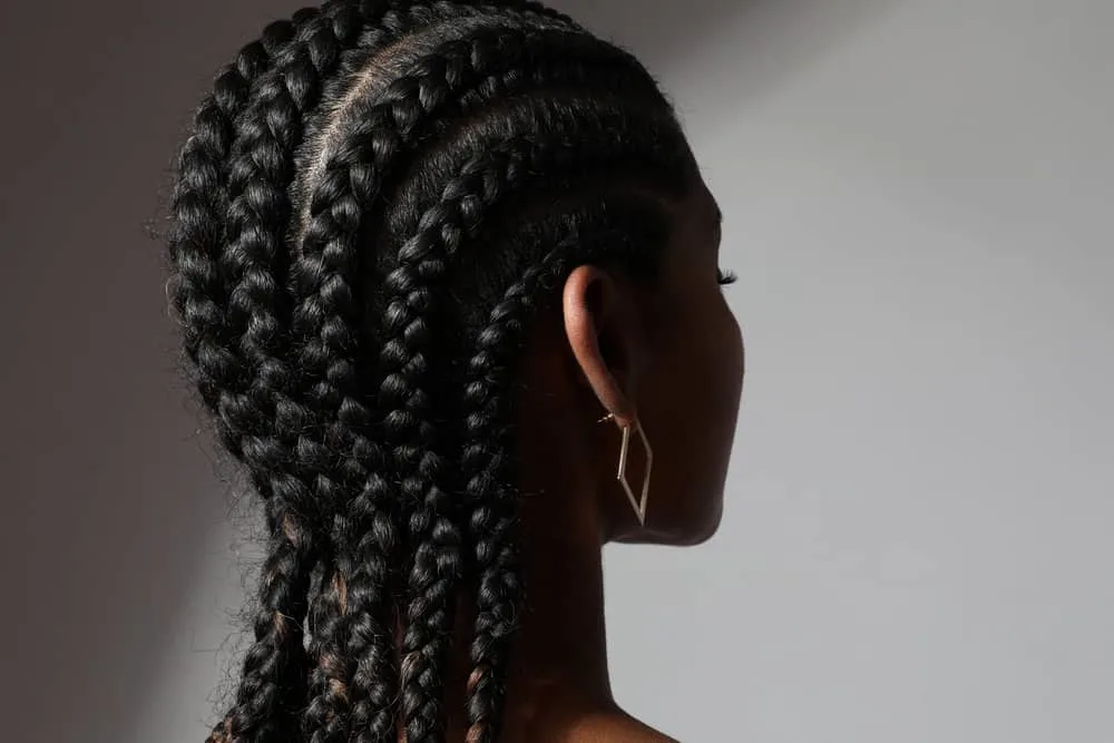 Cornrow Hair Growth Regimen: How Long to Keep Your Cornrows 3 An African female wearing her hair neat in long cornrow braids while she's trying to make her natural hair grow.