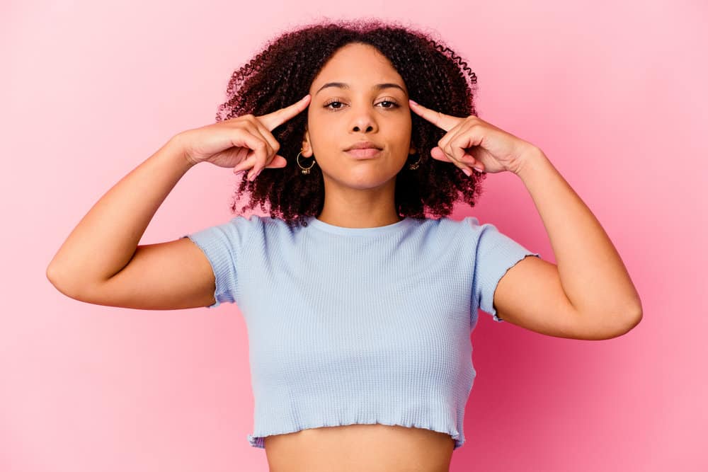 Black woman with natural, loose ringlets, unlike most other coily hair types, has type 4a hair that retains moisture.