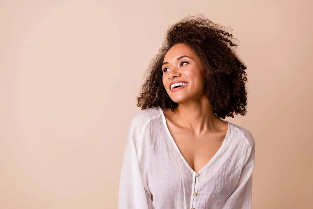 How Coconut Oil Ruined My Hair: The Dangers of Coconut Oil 4 Adorable African American female with curly natural hair has been using essential oils to promote hair growth.