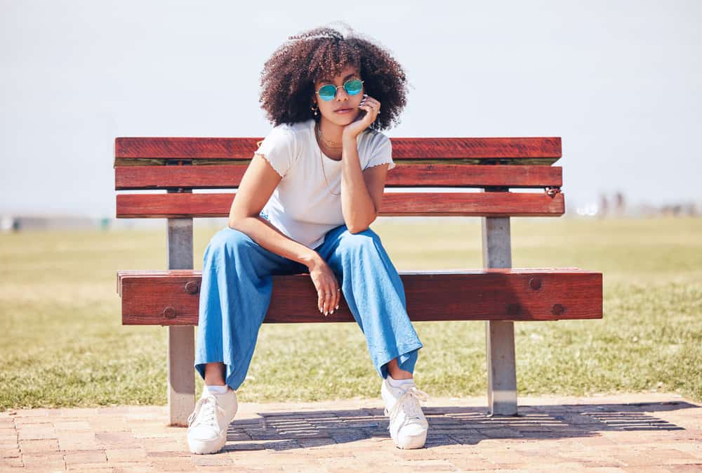 A stylish African American female with thin hair only two years now has much longer hair due a consistent regimen.