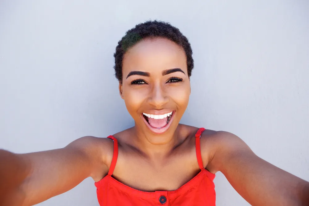Is My Hair Too Short for Braids? How to Braid Short Hair 1 A black girl with an oval face shape and very short hair is considering wearing braids on her 4B thick hair strands.