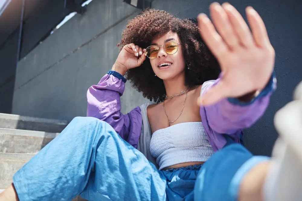 Can You Feel Your Hair Grow On Your Head? Face or Body? 4 A trendy black woman with healthy hair growth has been using a weekly scalp massage routine to improve blood circulation on her scalp.