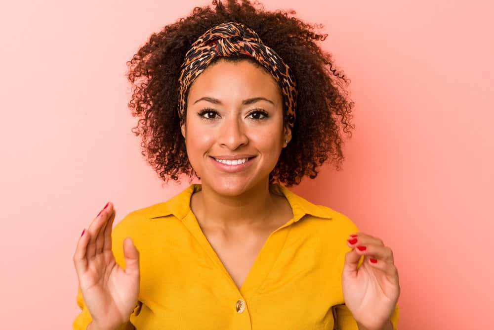 An African American lady that wants to remove hair color stains from her hair correctly to prevent potential damage.