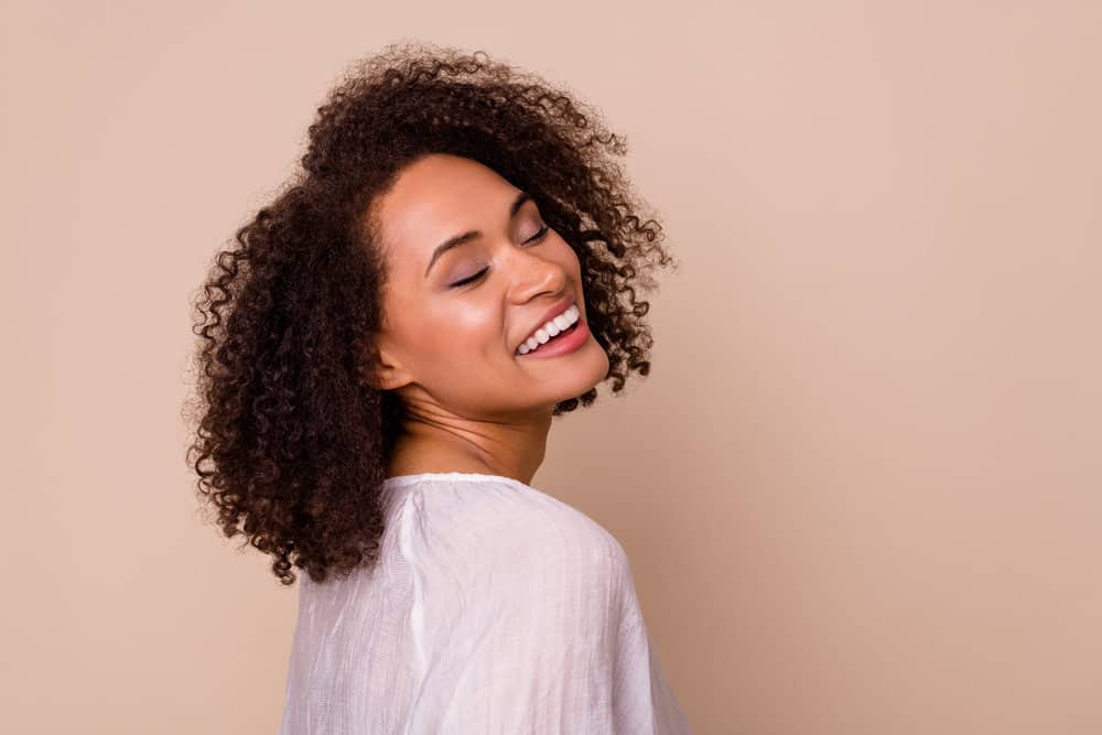 Light-skinned black female with type 3 hair strands that were styled coconut oil alternatives like castor oil.