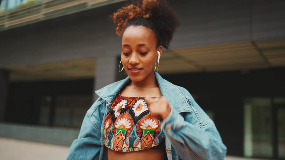 A young black female, after undergoing the bleaching process to make her dark brown curls shades lighter.