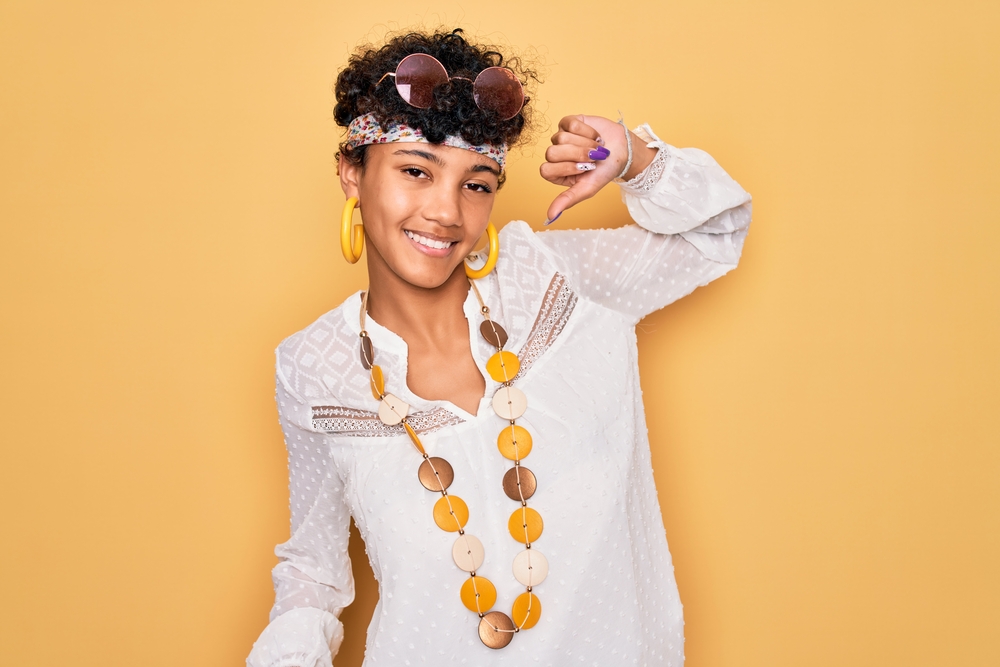 Young African American female with wispy layers wearing a shaggy bixie styled with a small round brush.