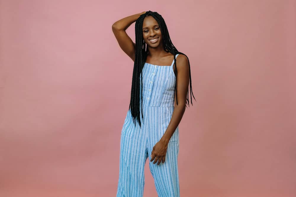 Young black girl that installed her own braids with proper preparation to protect her hair and scalp health.