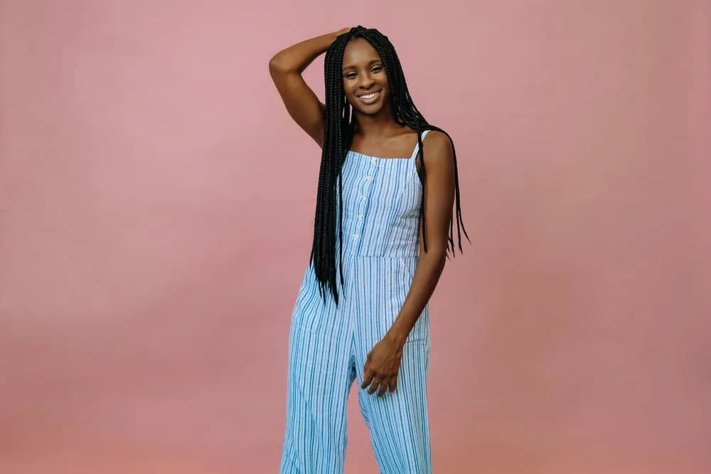 Should I Straighten My Hair Before Getting Braids or Stretch It? 4 Young black girl that installed her own braids with proper preparation to protect her hair and scalp health.