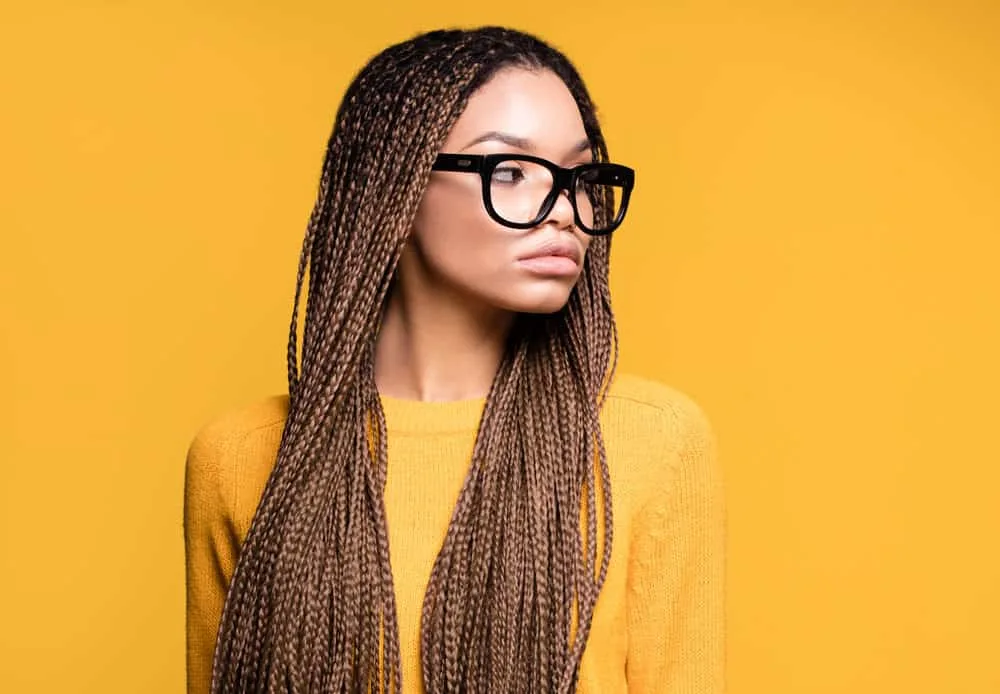 Learn How to Hide a Big Forehead With Braids Using These Styles 5 A beautiful African American with a long hair hairstyle suits her wide forehead - a messy look created on short hair.