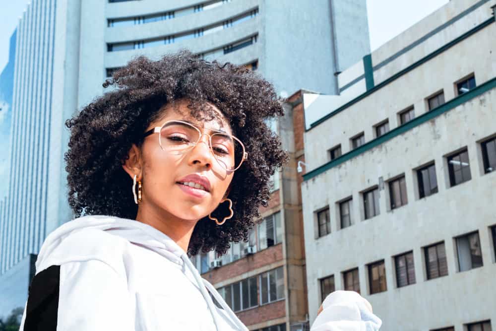 A lady with sensitive skin after using coconut oil shampoo on her damaged hair due to its natural ingredients.