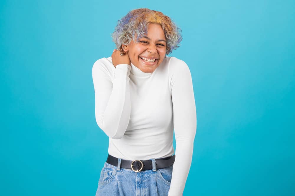 A young black girl after deciding to wash hair with a purple shampoo to keep her hair color vibrant.