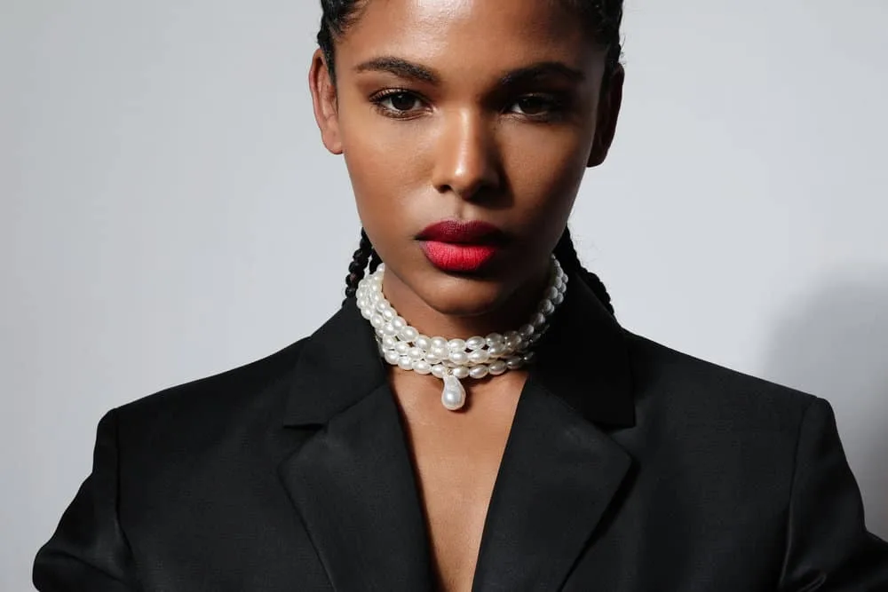 Cornrow Hair Growth Regimen: How Long to Keep Your Cornrows 7 Serious dark-skinned female with natural hair wearing a protective style to encourage length retention.