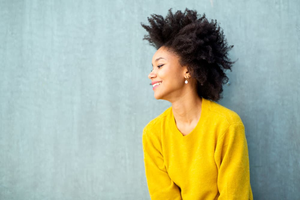 A young black girl with coily hair that normally wears twist-outs and wash n' go styles prefers super easy hairdos.