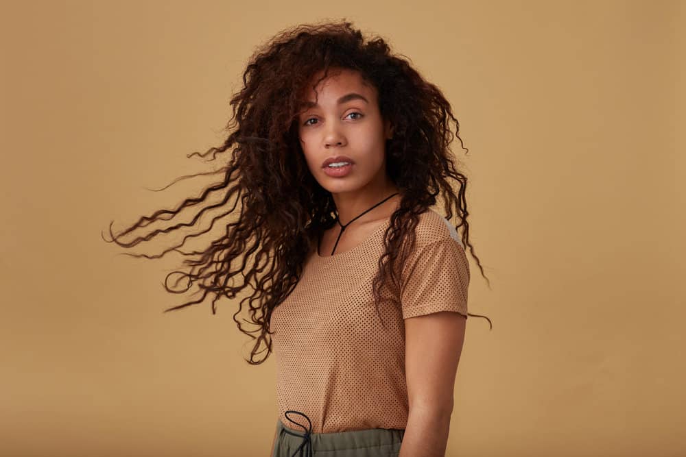 A light-skinned black girl wearing an increasingly popular 90s blowout to add volume to her normally flat hair.