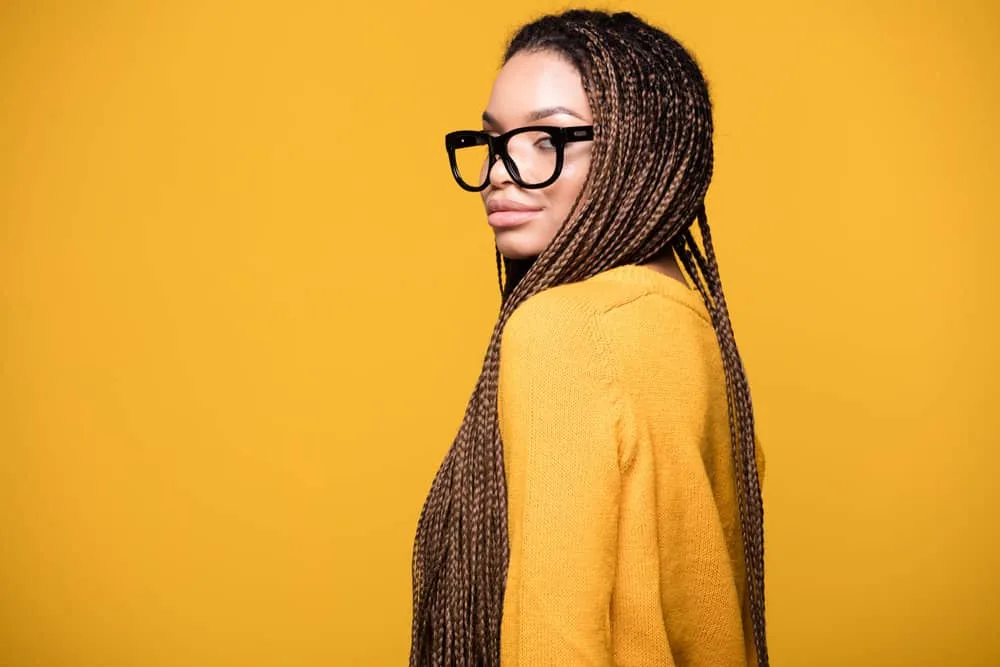 Learn How to Hide a Big Forehead With Braids Using These Styles 10 An attractive young woman with distinctive facial features and naturally wavy hair in a daring hairstyle.