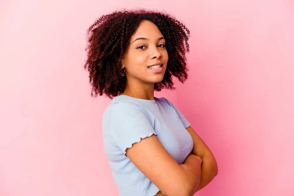 What Is 4A Hair? How To Take Care of It, Styles, and Products 4 Light-skinned black lady with one of the most common coily hair types (4A) for African American females.