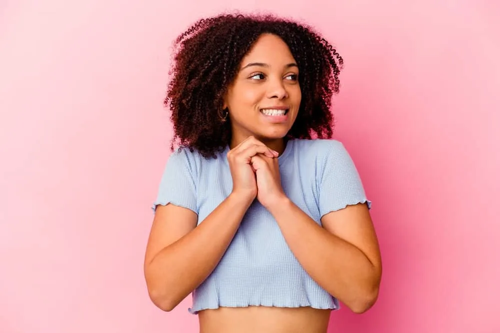 What Is 4A Hair? How To Take Care of It, Styles, and Products 2 A beautiful female wearing a cotton t-shirt wanting to limit hair shaft and cuticle damage with hot tools.
