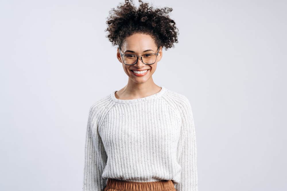 African American female with damaged hair from harsh chemicals is experiencing hair breakage and frizzy hair.