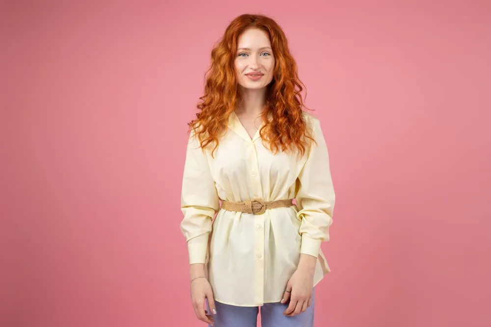 What Is 2A Hair? How To Take Care of It, Styles, and Products 2 A cute white girl with frizzy hair wearing beachy waves styled with a deep conditioning hair mask and sea salt spray.