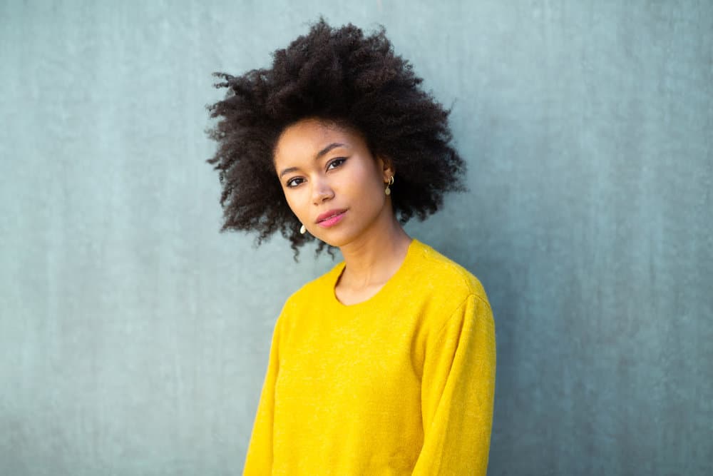 African American female with a coily hair type that has a defined curl pattern styled with essential oils.