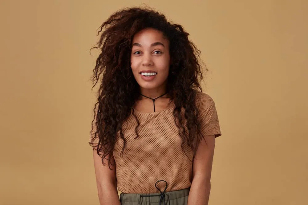 How to Do a 90s Blowout Style at Home on Short or Long Hair 12 In a YouTube video, an enthusiastic young lady, after dry-shampooing her curly hair in tiny sections.
