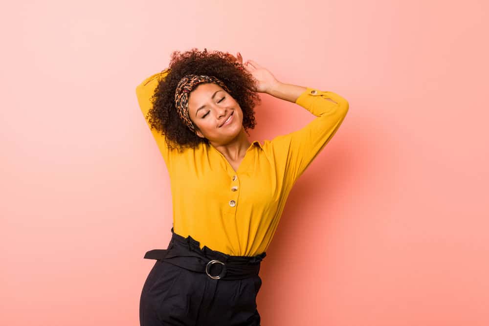 A light-skinned African female with natural curls cleaned with lemon juice and a sulfate-free shampoo.