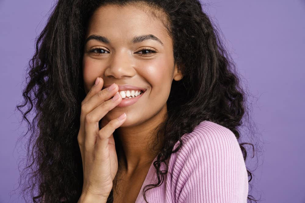 African American female with resistant gray hair (often written as grey hair) looking for ways to cover gray strands.