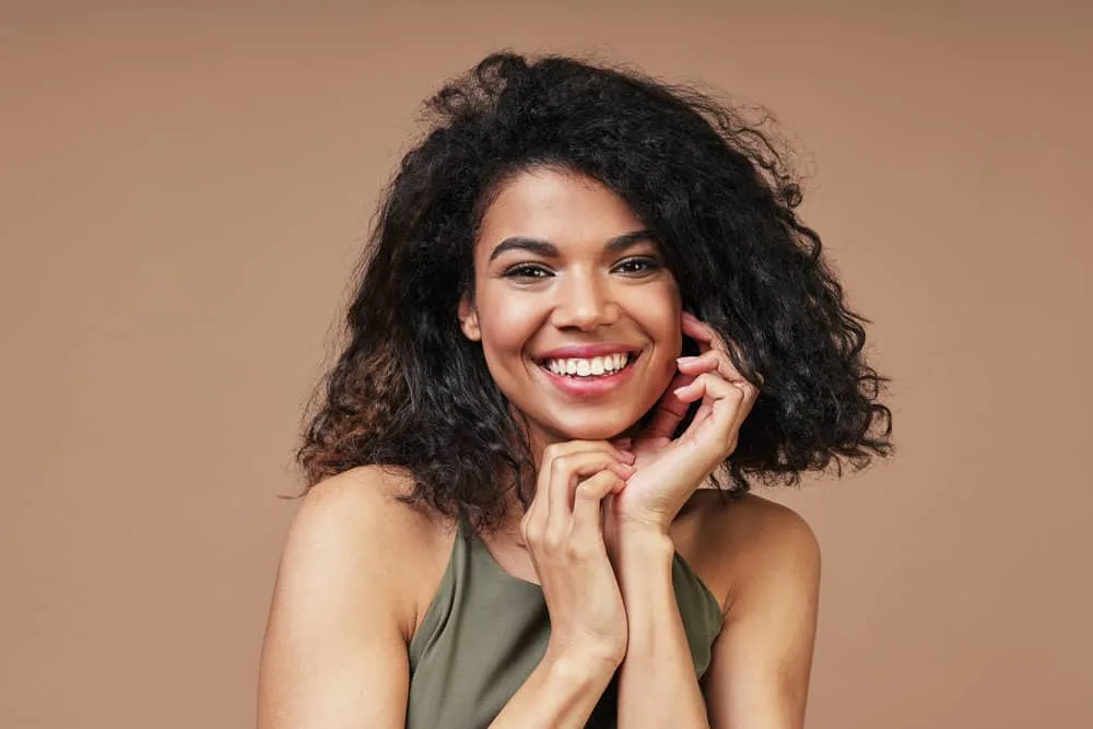 How to Get Curly Hair Back After Straightening It Too Much 5 Young black lady with bouncy curls after wearing her hair straightened consistently for over 12 months.