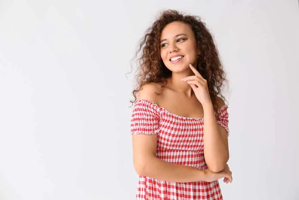 What Is 3B Hair? How To Take Care of It, Styles, and Products 7 A black lady with great curl definition on her low porosity hair strands styled with a lightweight leave-in conditioner.