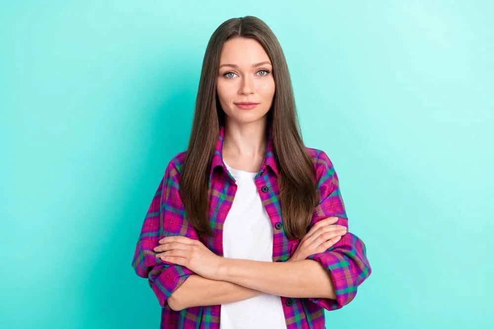 What Is 1C Hair? How To Take Care of It, Styles, and Products 12 Confident young white girl wearing naturally curly 1C hair strands that created their own natural moisture.