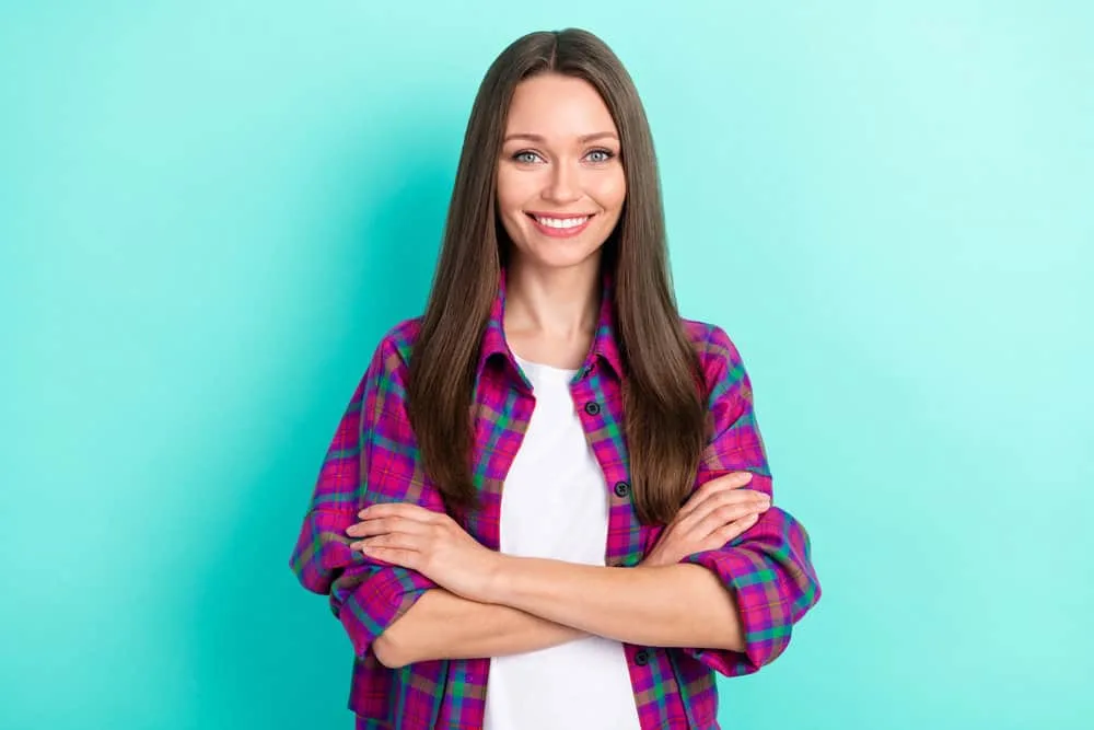 What Is 1C Hair? How To Take Care of It, Styles, and Products 10 A nice-looking brown-haired Caucasian female with both 1C and 2A wavy hair types on her medium texture strands.