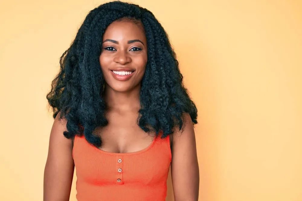 Can You Put Mousse on Synthetic Hair? Synthetic Wigs, Weaves & Braids? 1 A beautiful African American female with gorgeous curls on her 4A natural hair styled with organic styling products.