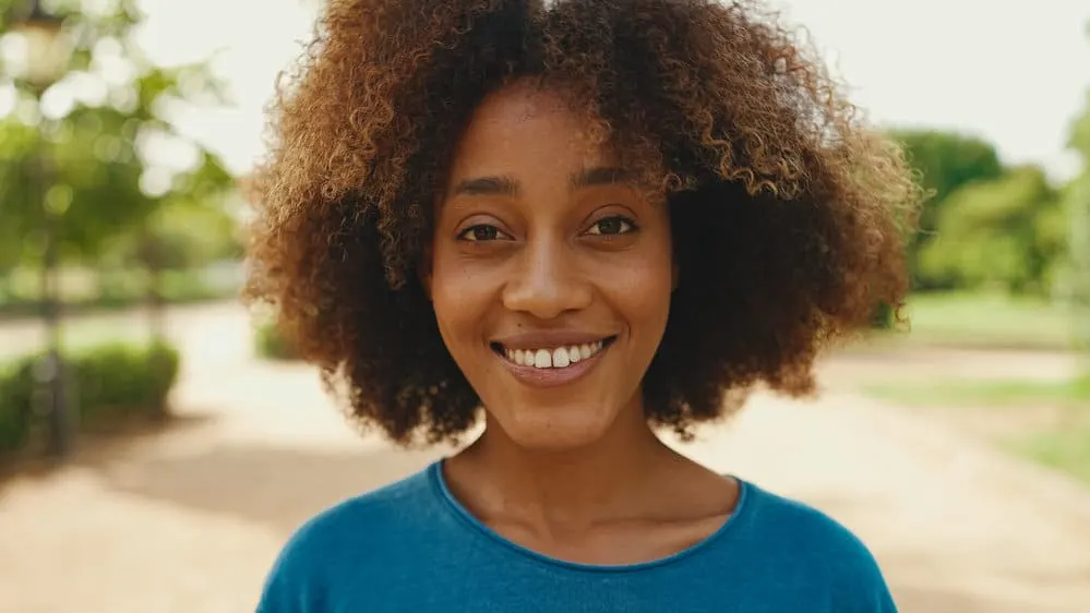 Crinkly Hair: Why Are Some of My Hair Strands Crinkly? 1 Young black girl with thick hair that is slightly wavy and curly wearing her coarse hair in an ombre style.