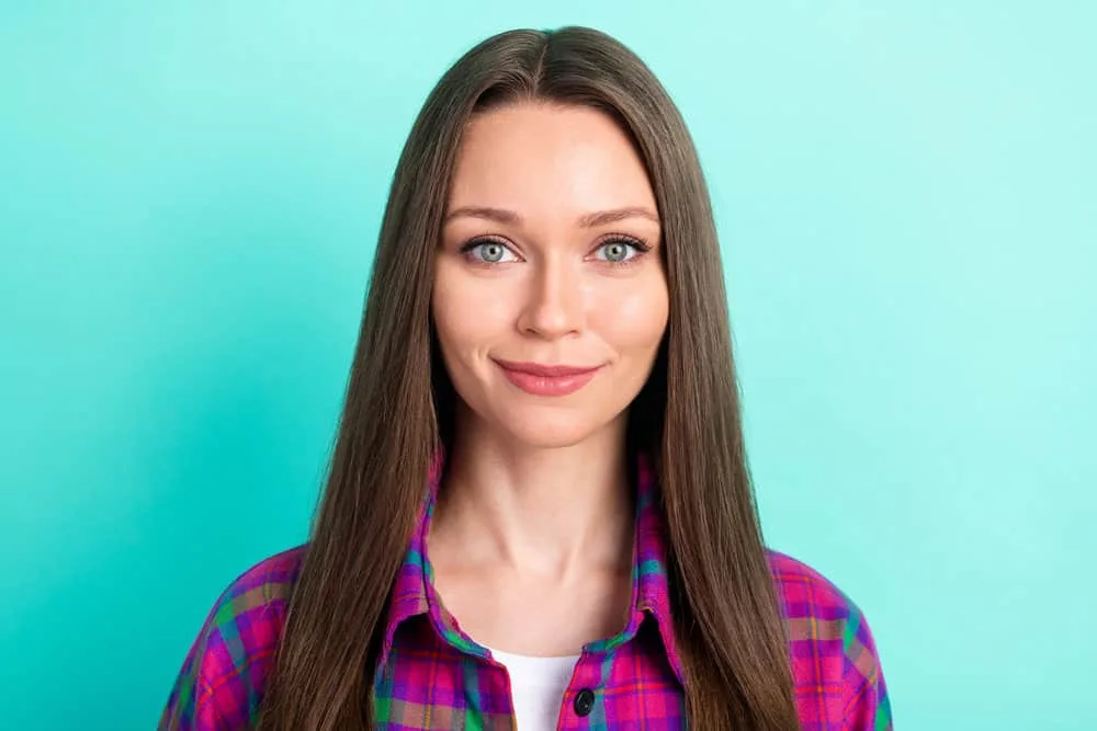What Is 1C Hair? How To Take Care of It, Styles, and Products 5 A joyful female with thin hair wearing her natural wave pattern on her mostly straight strands - common for 1C types.