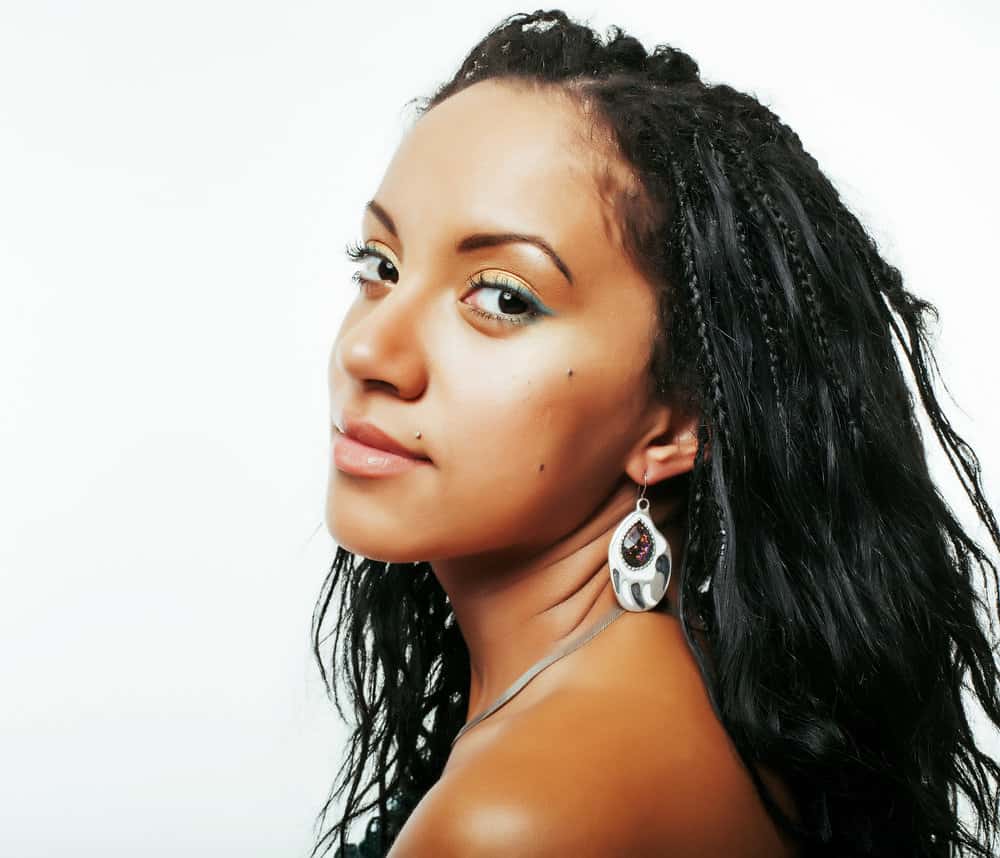 A cute young African American female with her long hair shedding has been using multiple hair loss treatments.