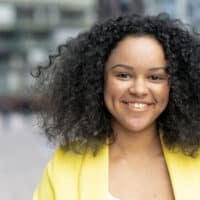 A light-skinned black girl with a professional keratin treatment on a medium-hair length curly natural texture.