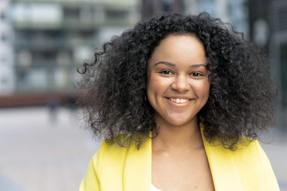 A light-skinned black girl with a professional keratin treatment on a medium-hair length curly natural texture.