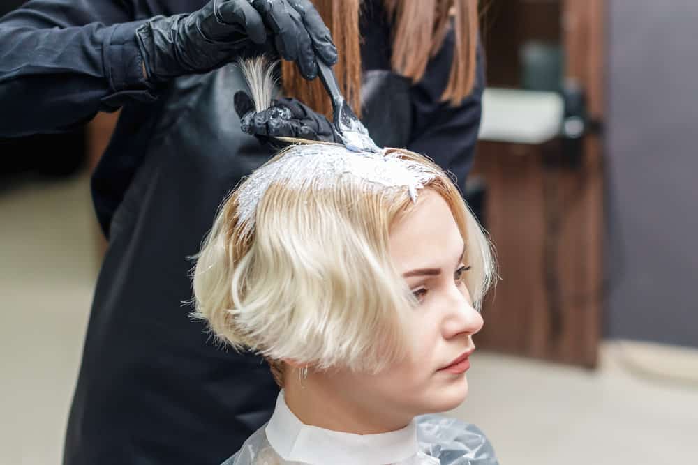 A cute white girl got a traditional hair color installed and ended up with hair color stains on her neck and cheek.